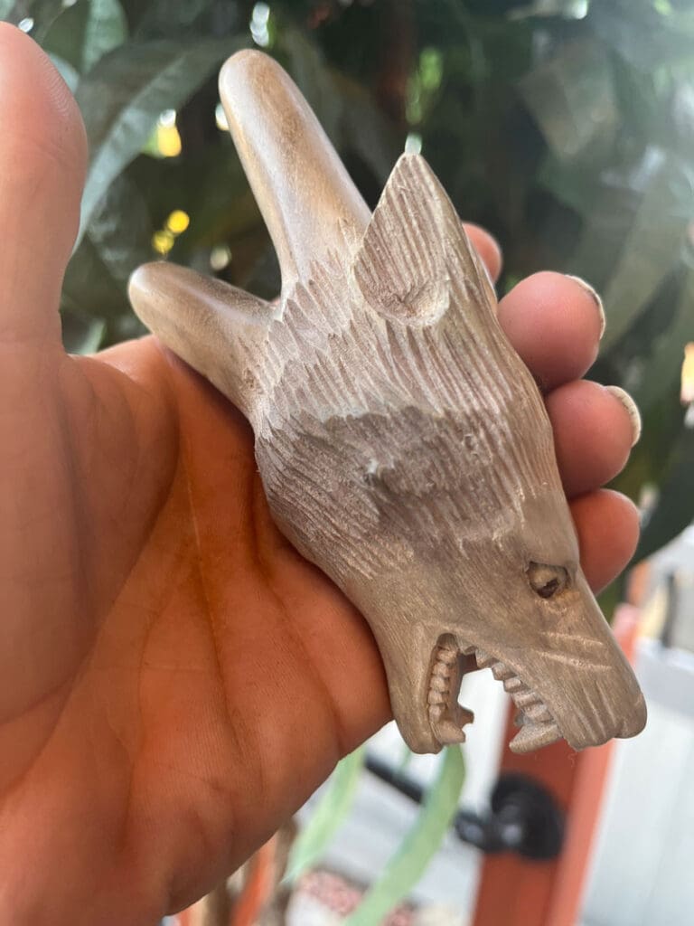 Hapé pipe with a wolf's head carved on it.